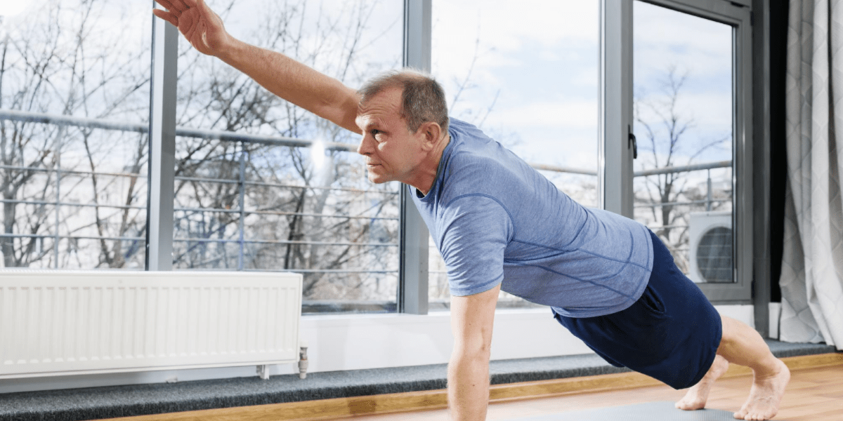 Middle aged man doing plank for flexibility routine