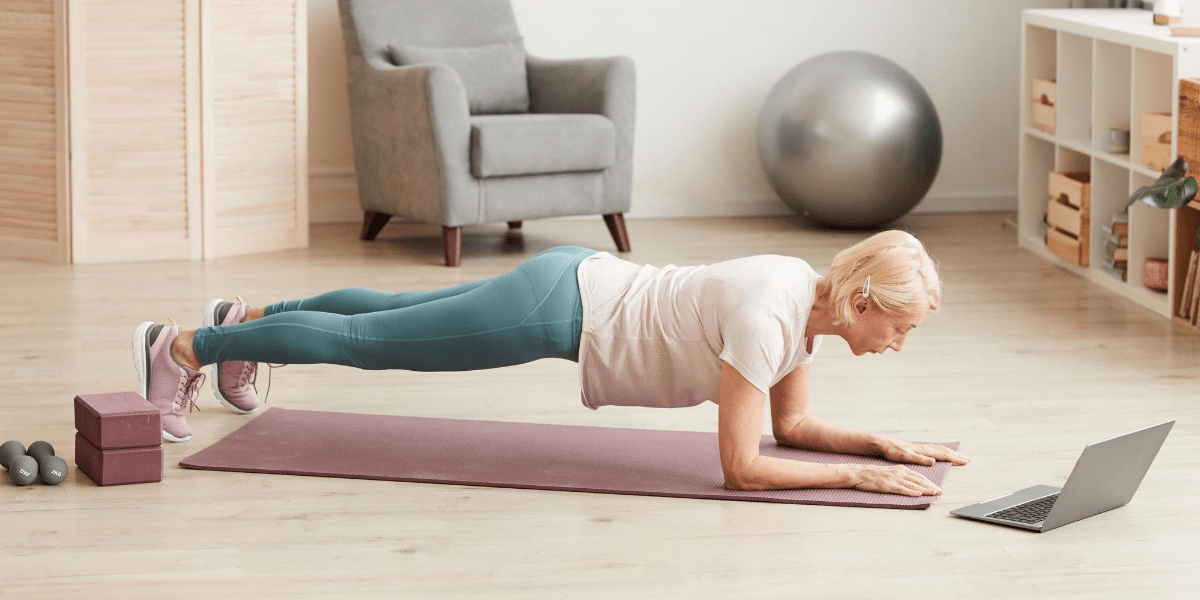 Middle aged woman doing plank to decrease back pain