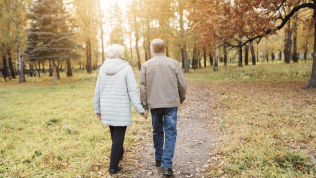 Healthy older couple with no hip pain walking in the park
